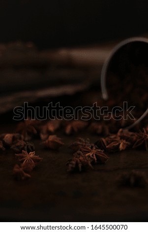 Traditional ingredients : anise star on a dark rustic background. 