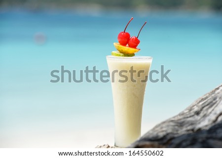 Milk cocktail on wood at beach - vacation background