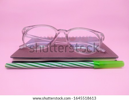 note book isolated on pink background, top view