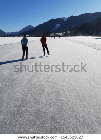 Ice-skaters on the frozen Weissensee in Austria
