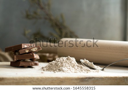  Teff flour on a wooden surface with chocolate on a rustic background