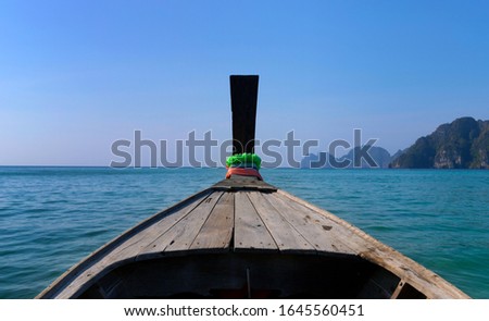 Traditional wooden boat in a picture perfect tropical bay on Koh Phi Phi Island, Thailand, Asia. Holiday travel and vacation on tropical island.