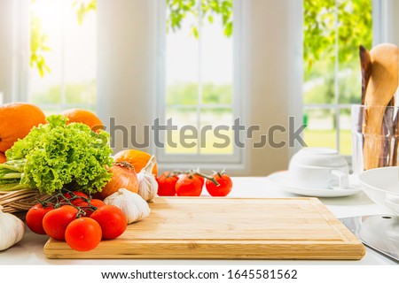empty wooden chopping board with fresh vegetables and spices, cook on a blurred background, morning kitchen window / area for you to edit products