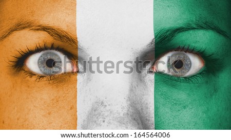 Close up of eyes. Painted face with flag of Ivory Coast