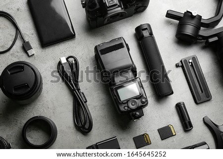 Flat lay composition with video production equipment for camera on light grey stone background
