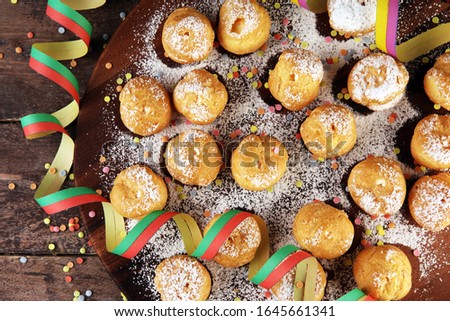 Krapfen or donuts with confetti and streamers. Colorful carnival or birthday party background