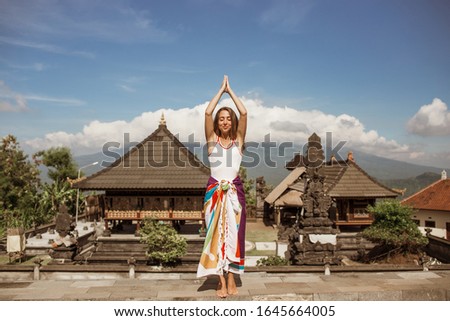 Young Woman looking on Batur volcano and Agung mountain view at morning, Bali, Indonesia