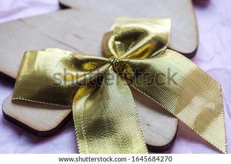 
toy in the form of a Christmas tree made of natural materials, for gift or decoration with a gold bow