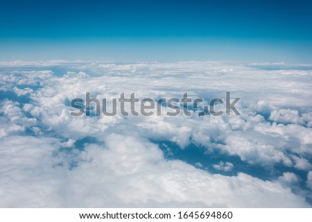Sky with clouds from airplane window during flight
