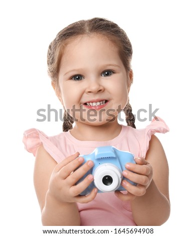 Little photographer with toy camera on white background