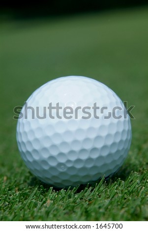 Close-up of golf-ball on green. Shallow depth of field.