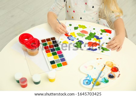 Little child painting at light table, closeup