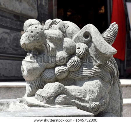 Head of a stone lion statue at a Chinese temple