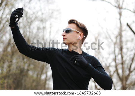 Healthy life. Athletic man in sportswear make selfie. Outdoor workout. Fitness app. Ui ux concept. Gadget in modern sport. Sport app on phone. Digital sport. Smart watch.