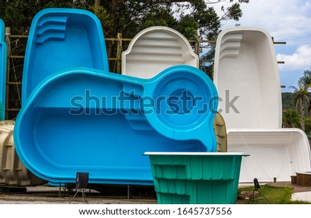 Exhibition of blue and white fiberglass pools Royalty-Free Stock Photo #1645737556