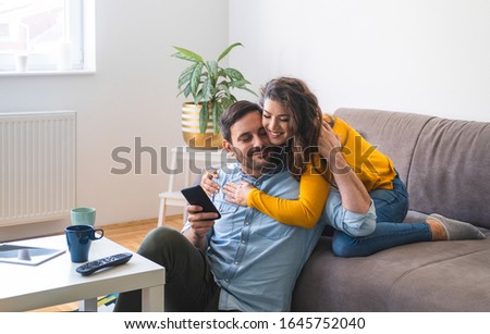 Couple embrace at home stock photo
