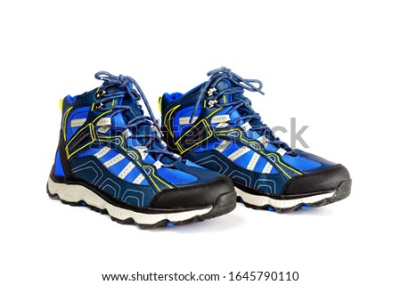 Warm men's sports-style boots with a waterproof surface, with laces. Background for sports and hiking shoes.
