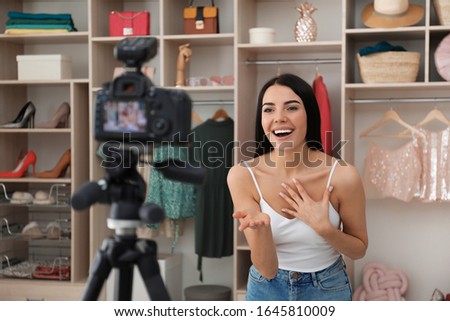 Emotional fashion blogger recording new video in room