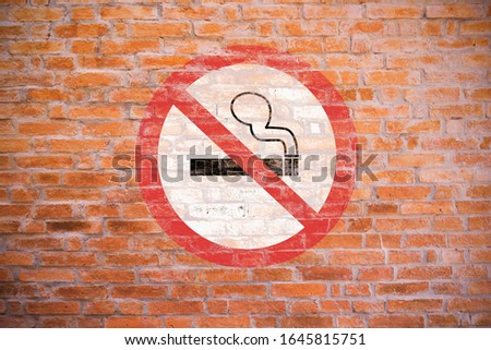 No smoking old sign paint on old brick wall, cigarette symbol in red circle
