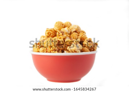 Golden Popcorn in red bowl with white background 