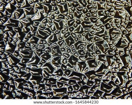 abstract background with a chaotic pattern of embossed surface made of opaque glass