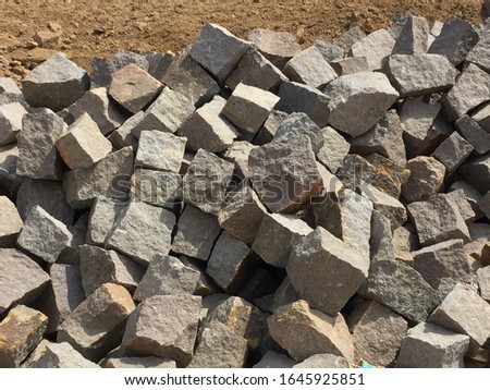 rocks broken from the mountain which is being used for house construction