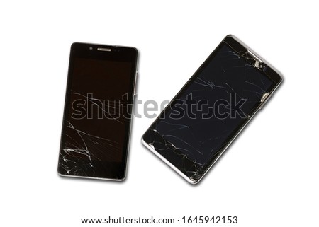 Two broken phones. Broken screens. View from above. On white background. Isolated