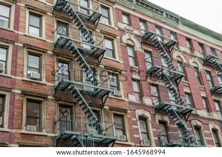 Typical Manhattan Apartments with Fire Escape Ladders in New York City, USA. Low Angle View of an Apartment Block