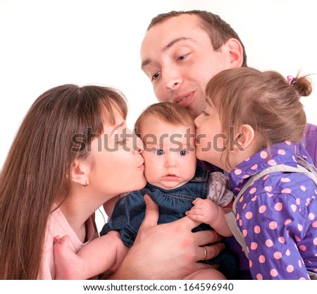 father and mother kissing her baby over white background 