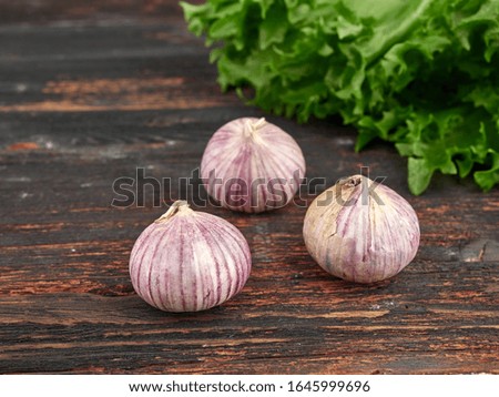 Fresh garlic on market table closeup photo. Vitamin healthy food spice image. Spicy cooking ingredient picture.