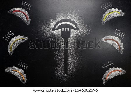 Dumpling on a fork. Drawing on a black chalkboard	
