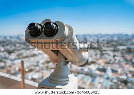 Binoculars on rooftop of building for seeing city view