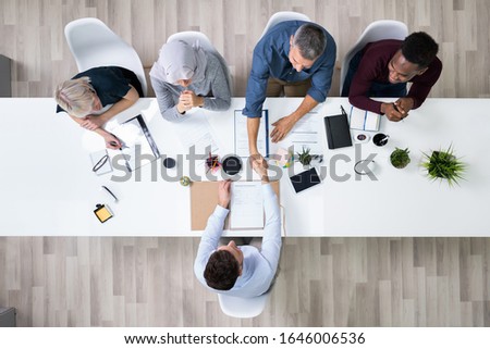 Group Of Corporate Recruitment Officers Shaking Hand With Candidate Arrived For Interview Royalty-Free Stock Photo #1646006536