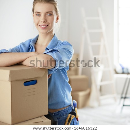 Portrait of a young woman with boxes