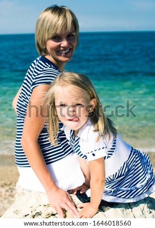 mother with daughter at sea cost together, happy real family smiling looking to horizont, lifestyle people concept, on vacations close up