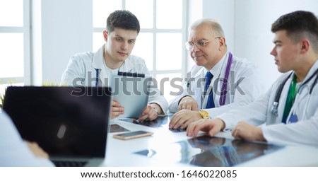 Medical team sitting and discussing at table