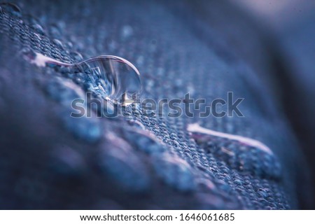Water drops on impregnated waterproof fabric. Royalty-Free Stock Photo #1646061685