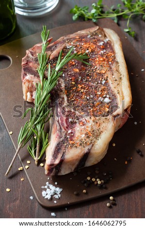 Dry Aged Beef. Raw Cowboy Rib or Rib Eye Steak with Herbs and Spices