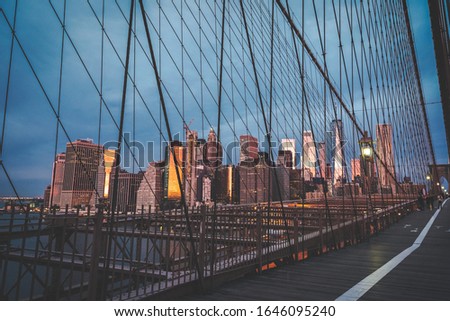 A view of Lower Manhattan skyline from from Brooklyn Bridge at sunrise
