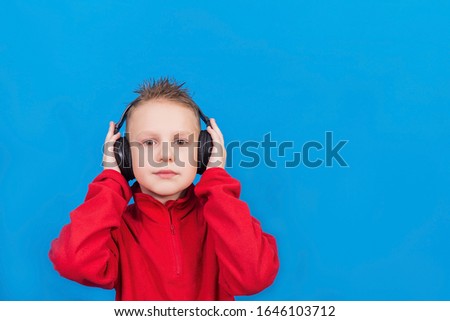 Boy with headphones on a blue background
