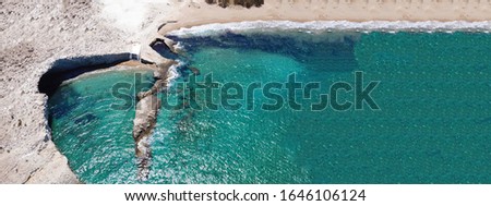 Aerial drone ultra wide photo of famous volcanic white rocky beach of Alogomandra with natural shady cave, Milos island, Cyclades, Greece