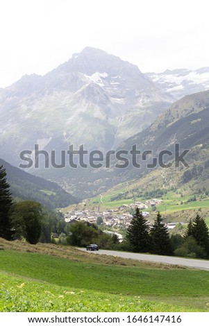 Fresh green spring grass meadow alps valley mountain top high peak panorama view vertical outdoor nature background