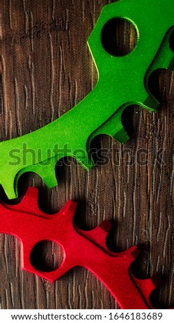 Red and green Face Narrow Wide Chainring over wooden background