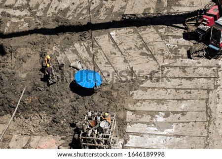 Pictures of strong construction workers digging in the city