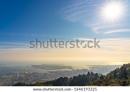 Kobe city panoramic view from Mt. Maya Kikusedai park observatory platform in sunny day sunset time with blue sky background, famous by the 10 ten million dollar night views. Hyogo Prefecture, Japan