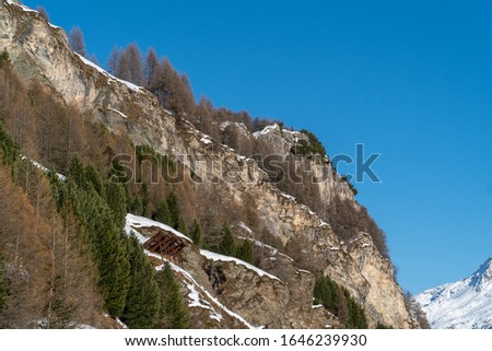 Panoramic view on winter snowy mountains at nice sunny evening. Swiss alps during summer.