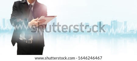 Businessman using tablet analyzing sales data and economic growth graph chart. Business strategy. 