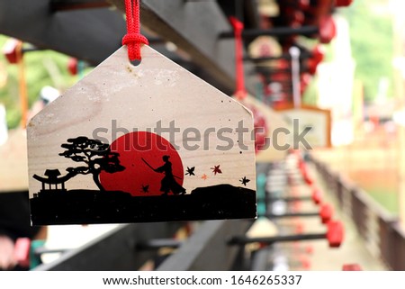 A wooden board with Japanese Samurai Picture. This board is used for hanging hope in Japan culture. 