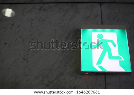 green exit sign on the wall
