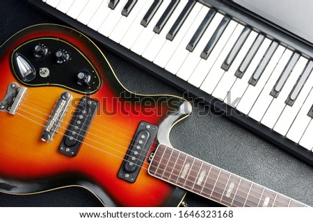 Keyboard synthesizer and electric guitar.
